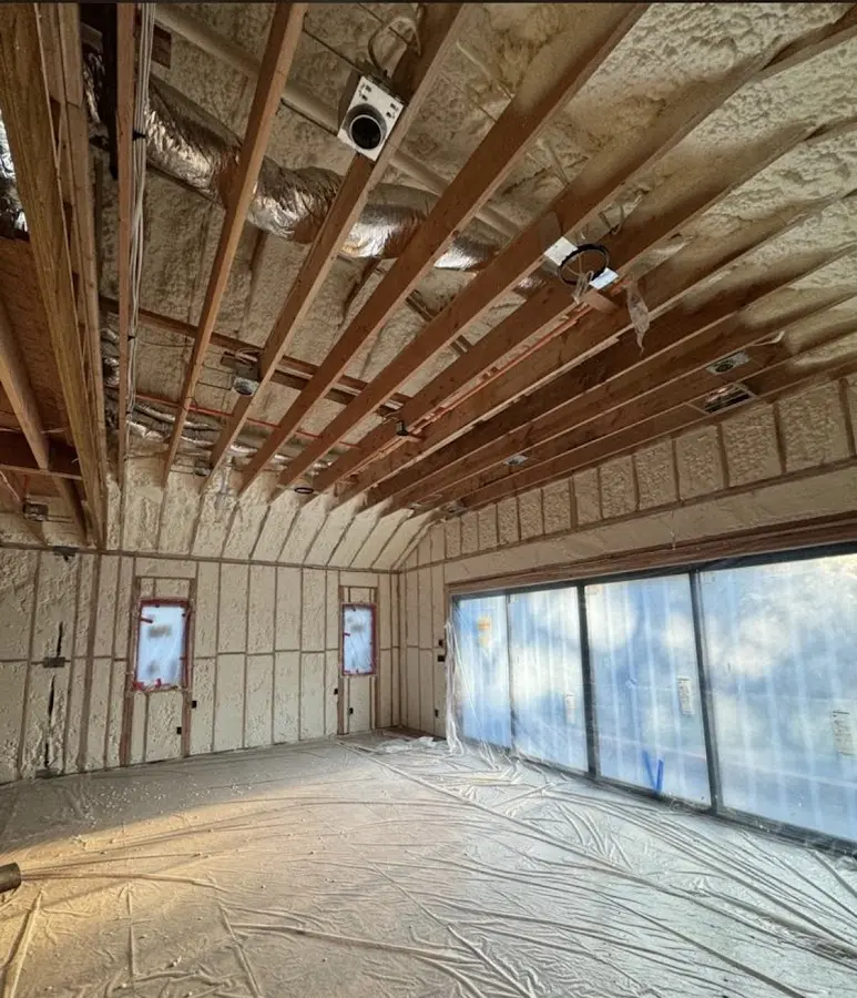 Interior walls and ceiling insulated with spray foam during new construction in Mila Doce